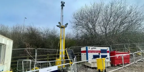 Blog Wide CCTV Tower behind temporary fencing on a site