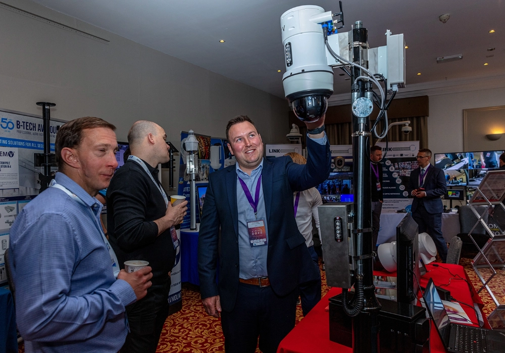Exhibition Visitors Looking at WCCTV Cameras